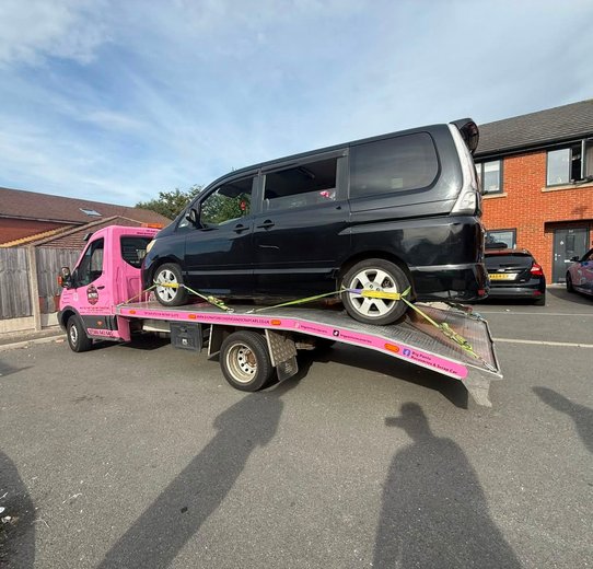 Silver Hatchback loaded on pink truck