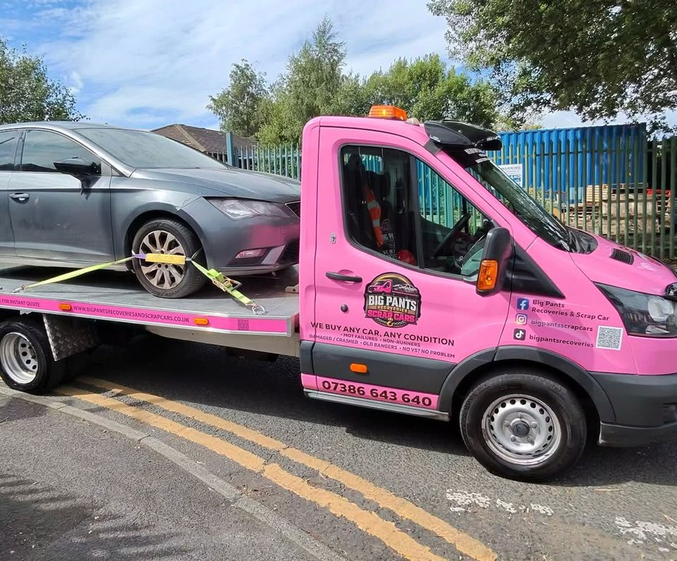 car being collected by truck