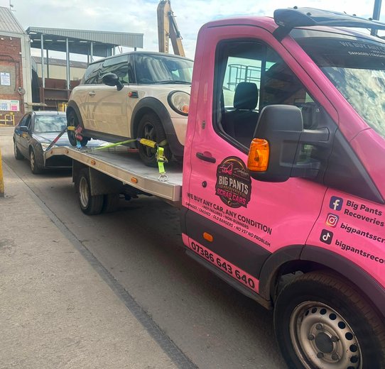 Mini loaded on pink truck