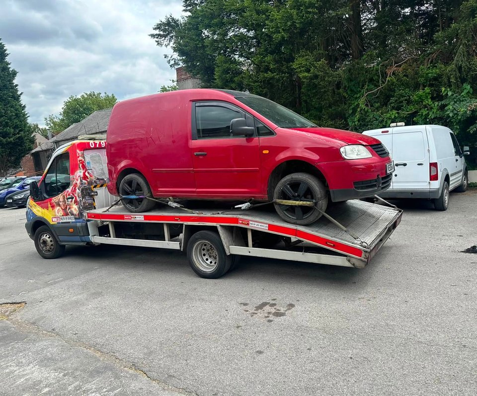 van being collected by truck